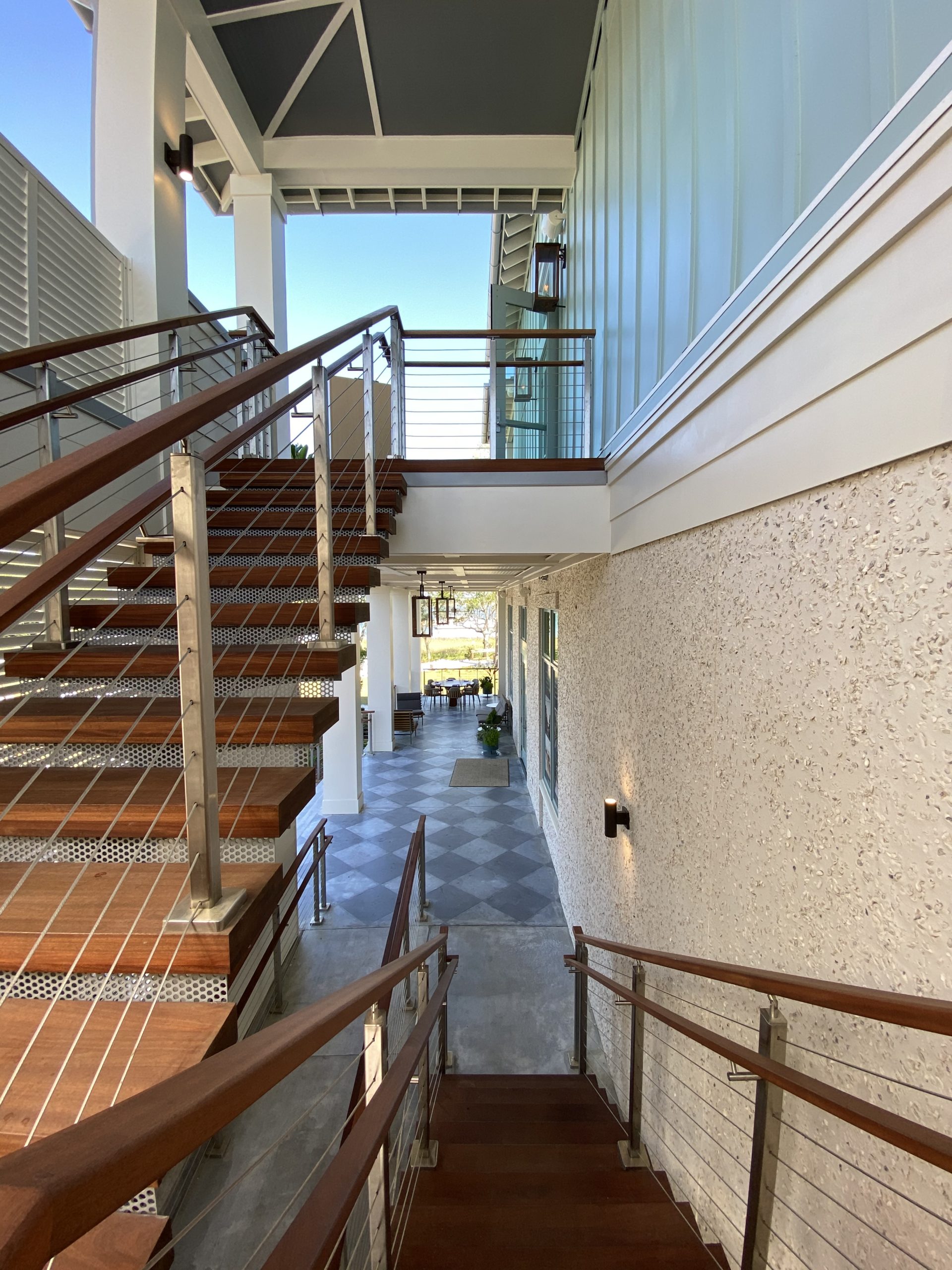 Open staircases constructed by Lennon Construction connect the outdoor spaces at The Kingstide in Daniel Island.